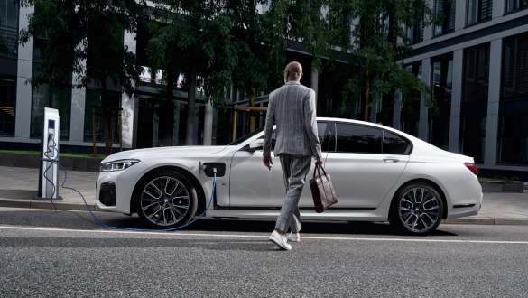 Plug-in hybridní BMW řady 7 Sedan G11 G12 pohled z boku při nabíjení Plug-in hybridní BMW řady 7 Sedan G11 G12 pohled z boku při nabíjení s modelem