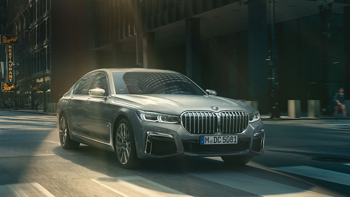 Driving Assistant Professional: tříčtvrteční pohledu zepředu na jedoucí BMW řady 7 Sedan v městském prostředí BMW řady 7 Sedan Driving Assistant Professional