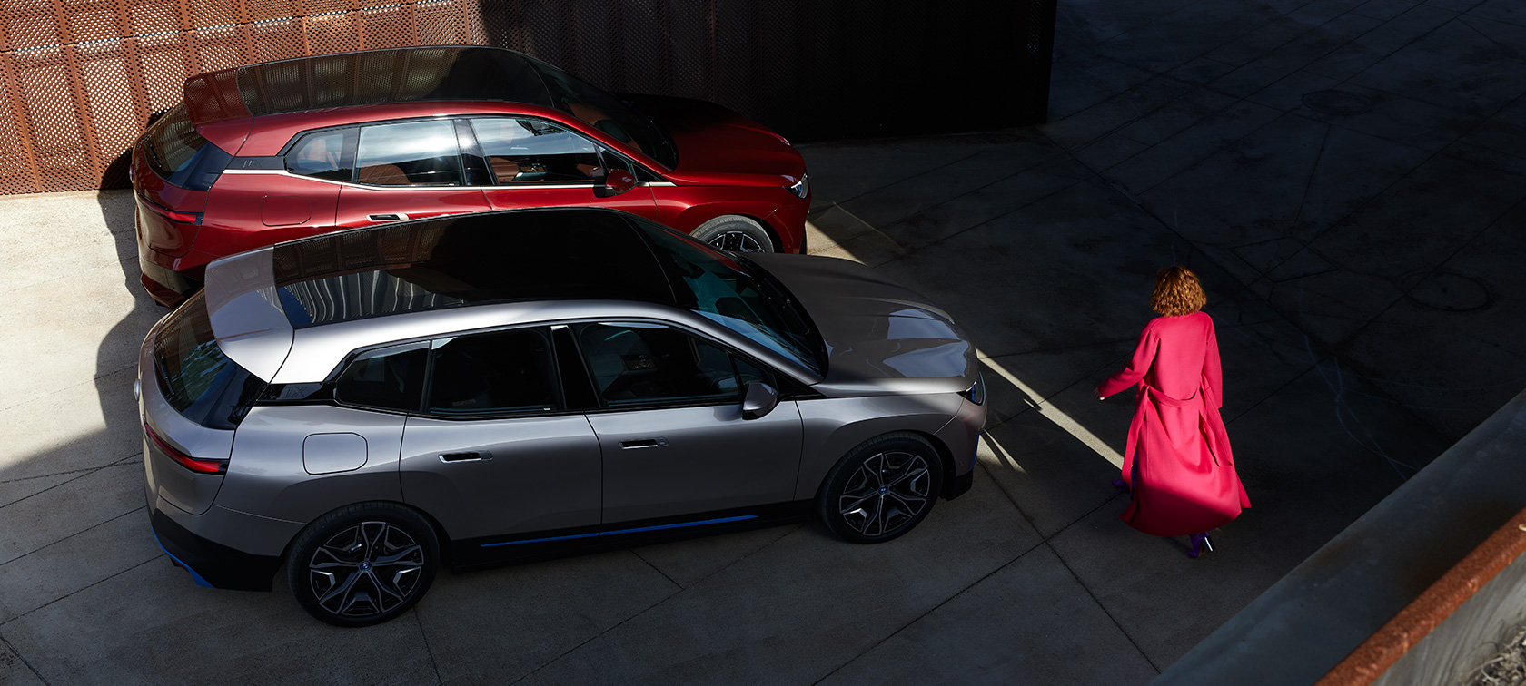 BMW iX pohled shora s modelem BMW iX Aventurin Red a Cashmere Silver i20 pohled shora s modelem