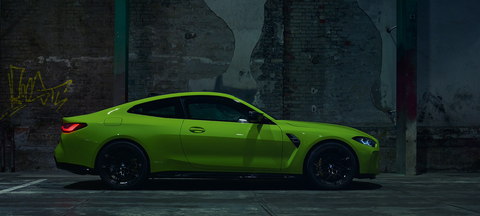 BMW M4 CSL G82 tříčtvrteční pohled zezadu BMW M4 CSL G82 BMW Individual metalický lak Frozen Brooklyn Grey (šedá) jízdní tříčtvrteční záběr zezadu na okruhu